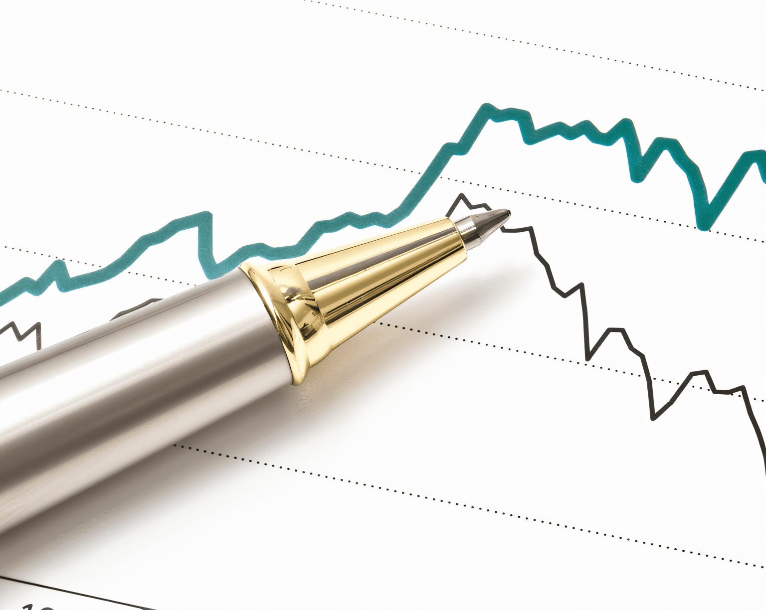 Pen on financial graph showing trends.