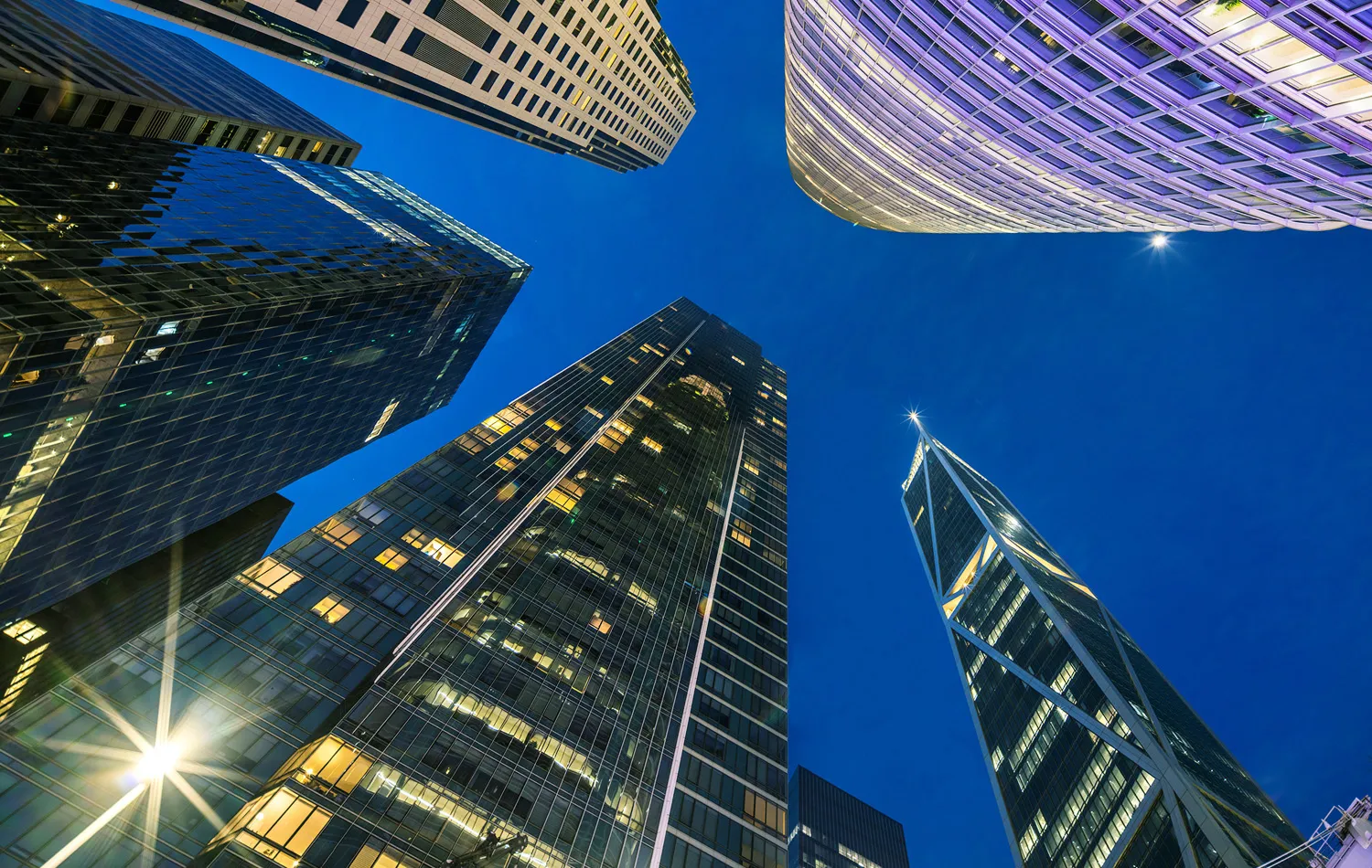 Skyscrapers against a twilight blue sky.